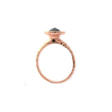 Crafted in 14KT rose gold, this ring features a diamond halo with a black rose-cut diamond centre and a quilted band.