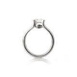 Crafted in 14KT white gold, this ring features a half-bezel set round brilliant-cut diamond with signature trademark on both sides.