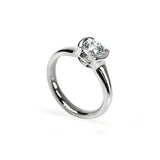 Crafted in 14KT white gold, this ring features a half-bezel set round brilliant-cut diamond with signature trademark on both sides.