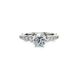 Crafted in 14KT white gold, this ring features a round brilliant-cut centre diamond on a diamond-set band. 