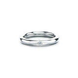 Simple band crafted in 14KT white gold, featuring a small centre diamond.