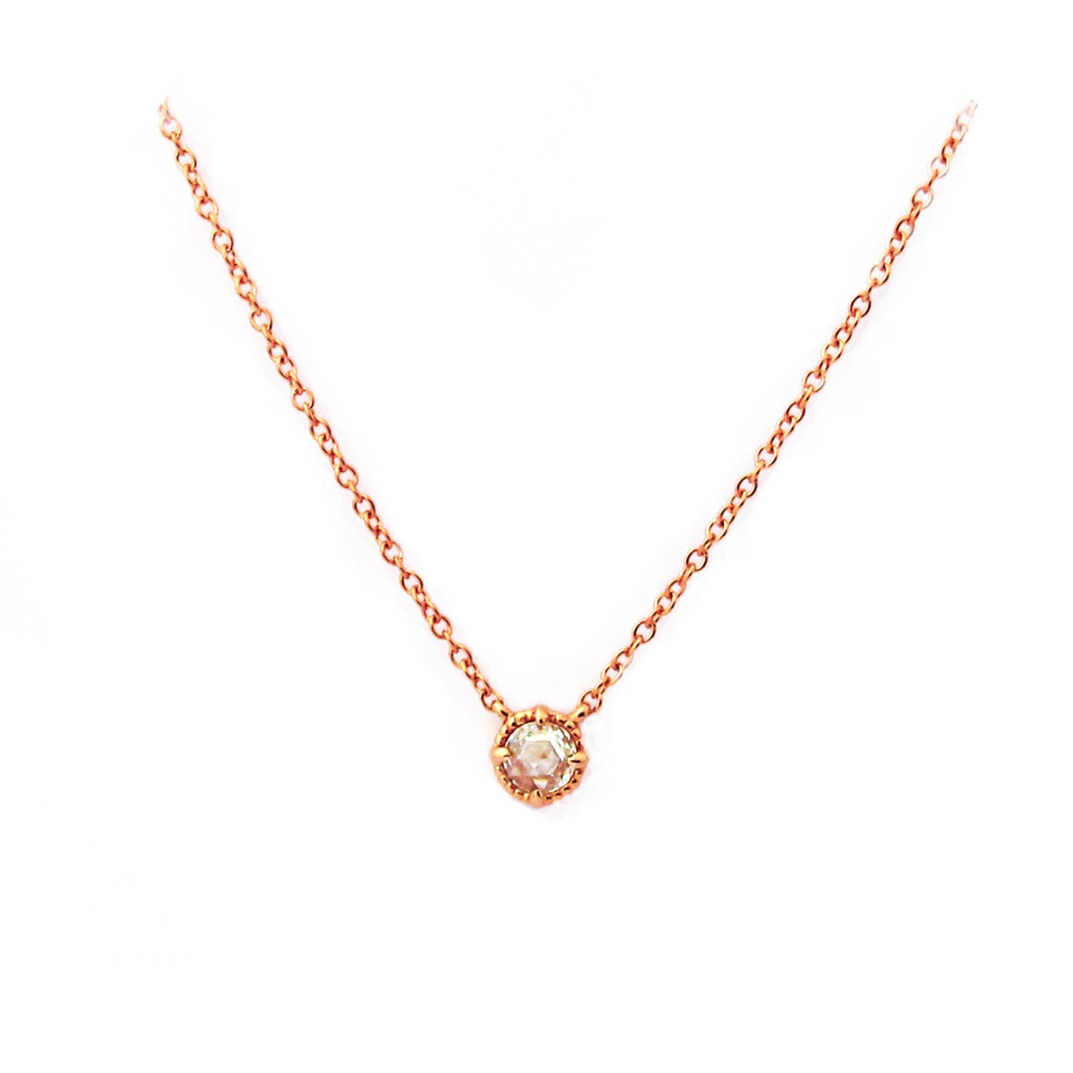 Crafted in 14KT gold, this necklace is set with a white rose-cut diamond.
