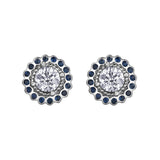 Crafted in 18KT white Canadian Certified Gold, these stud earrings feature regal blue sapphire halos with round brilliant-cut Canadian centre diamonds.