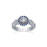 Crafted in 18KT white Canadian Certified Gold, this ring features a regal blue sapphire halo with a round brilliant-cut Canadian centre diamond on a frost-inspired hand engraved band.