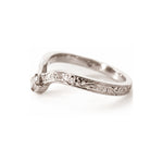 A white gold band ring with delicate floral engraving and a small clear gemstone, shown on a plain white background.