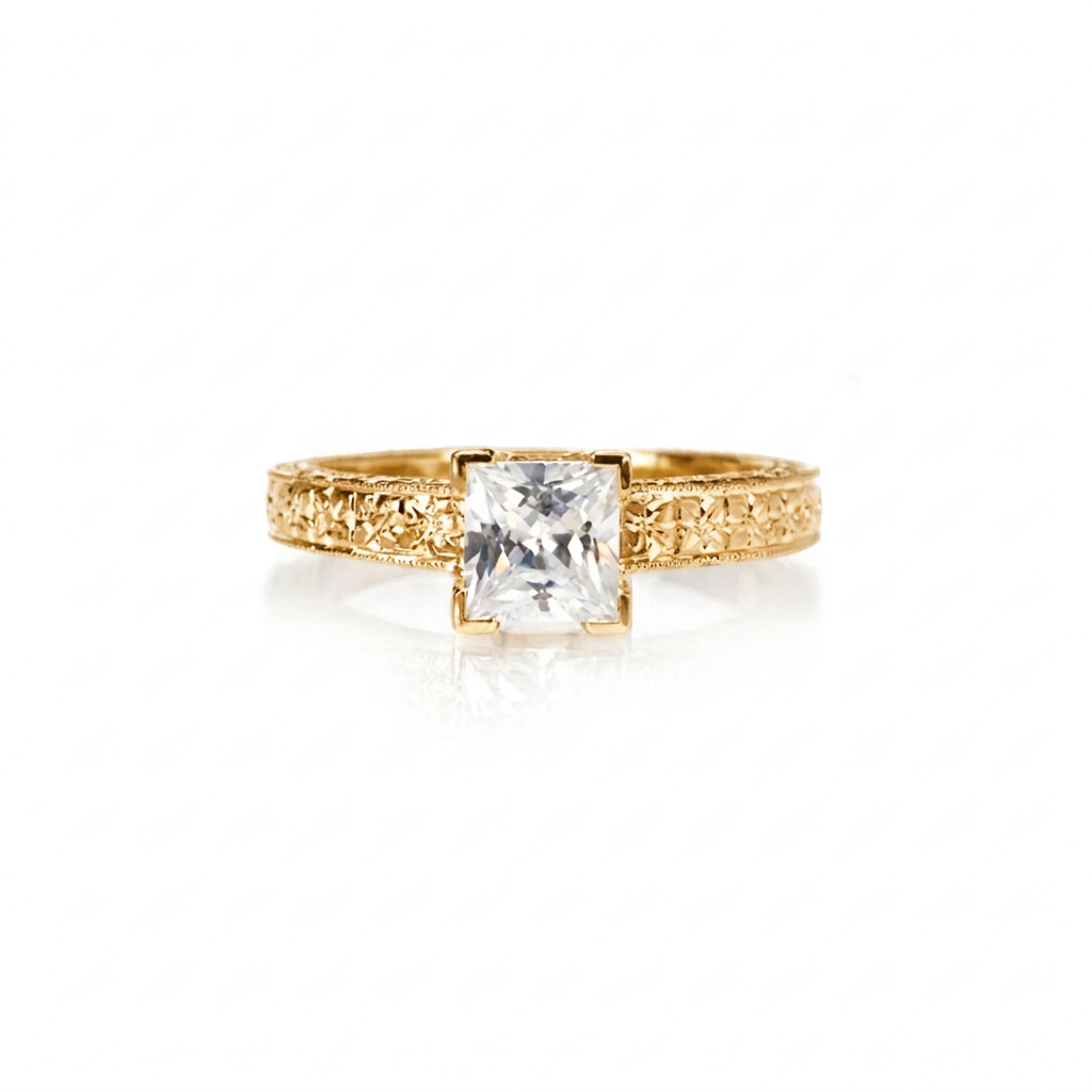 Crafted in 14KT gold, this engagement ring features a princess cut diamond in a four-prong setting on an orange blossom hand-engraved band.