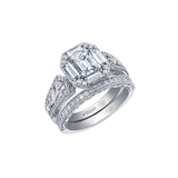 18k white gold ring with emerald-cut Canadian diamond, frost engravings, diamond halo, and blue sapphire.