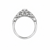 18kt gold engagement ring with oval-cut Canadian diamond, diamond side stones, and intricate rose vine detailing, 0.45 TDW.
