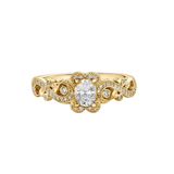 18kt gold engagement ring with oval-cut Canadian diamond, diamond side stones, and intricate rose vine detailing, 0.45 TDW.