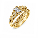 18kt gold engagement ring with oval-cut Canadian diamond, diamond side stones, and intricate rose vine detailing, 0.45 TDW.