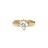 Crafted in 14KT gold, this engagement ring features a princess-cut diamond in a diagonal prong setting. 