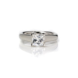  Crafted in 14KT gold, this engagement ring features a princess-cut diamond with v-shaped prongs holding it in place. 
