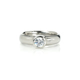 Crafted in 14KT gold, this engagement ring features a bezel set round brilliant-cut diamond. 