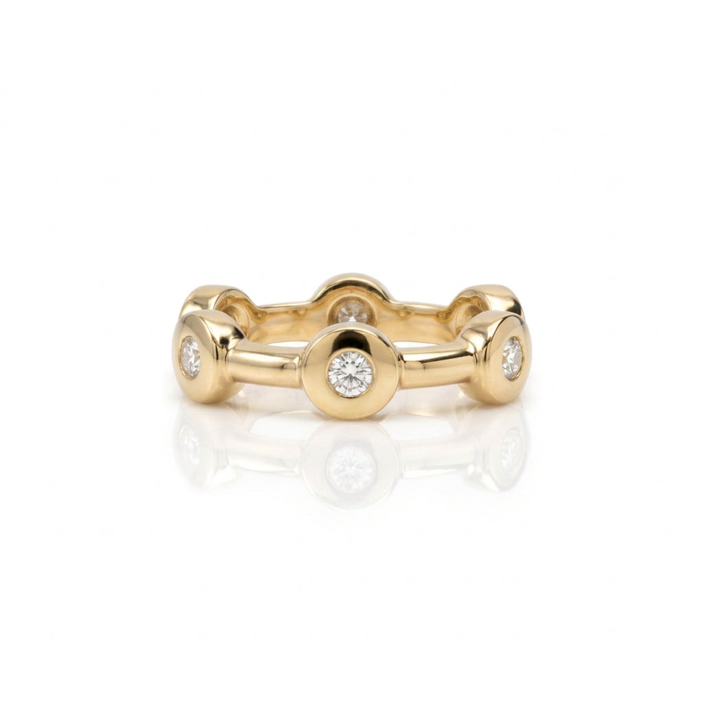 Crafted in 14KT gold, this ring features six round brilliant-cut diamonds spaced apart in bezel settings. 