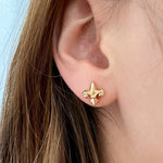 10 x 9mm fleur-de-lis stud earrings in 14K yellow, rose, or white gold, featuring an elegant royal-inspired design.