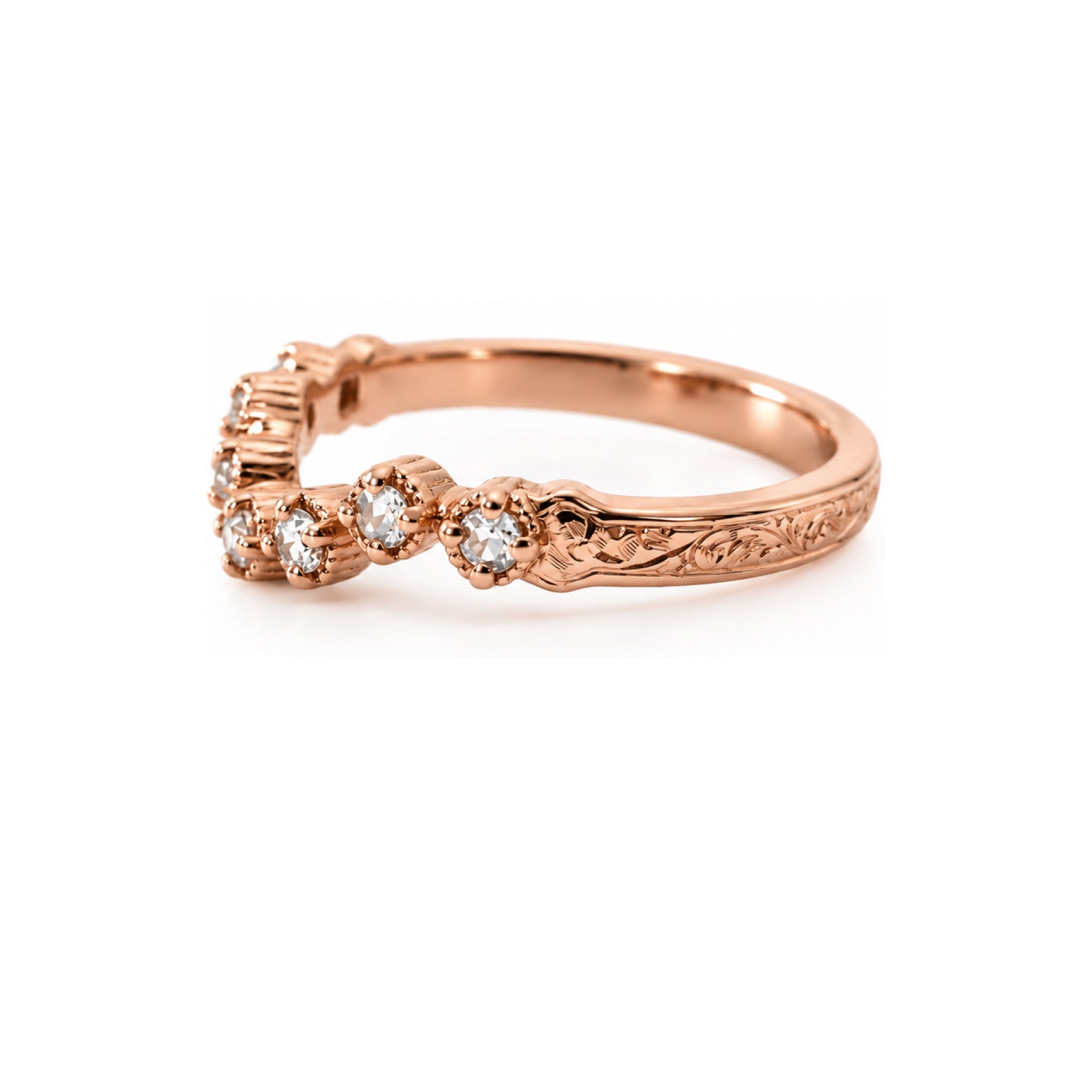 A rose gold ring with a floral cluster setting of clear round-cut gemstones and an engraved band, shown on a clean white background.