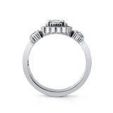 A silver-toned diamond ring with a central round-cut diamond and smaller diamonds set in decorative side clusters, shown from the back on a white background.