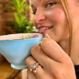 Jaqueline Ring and Alexandra Ring with hand-engraving, rose-cut diamonds and blue sapphire accent stones on woman’s hand