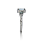14kt gold vintage-style ring with emerald-cut aquamarine centre and two round alexandrite gemstones, featuring hand-engraved details.