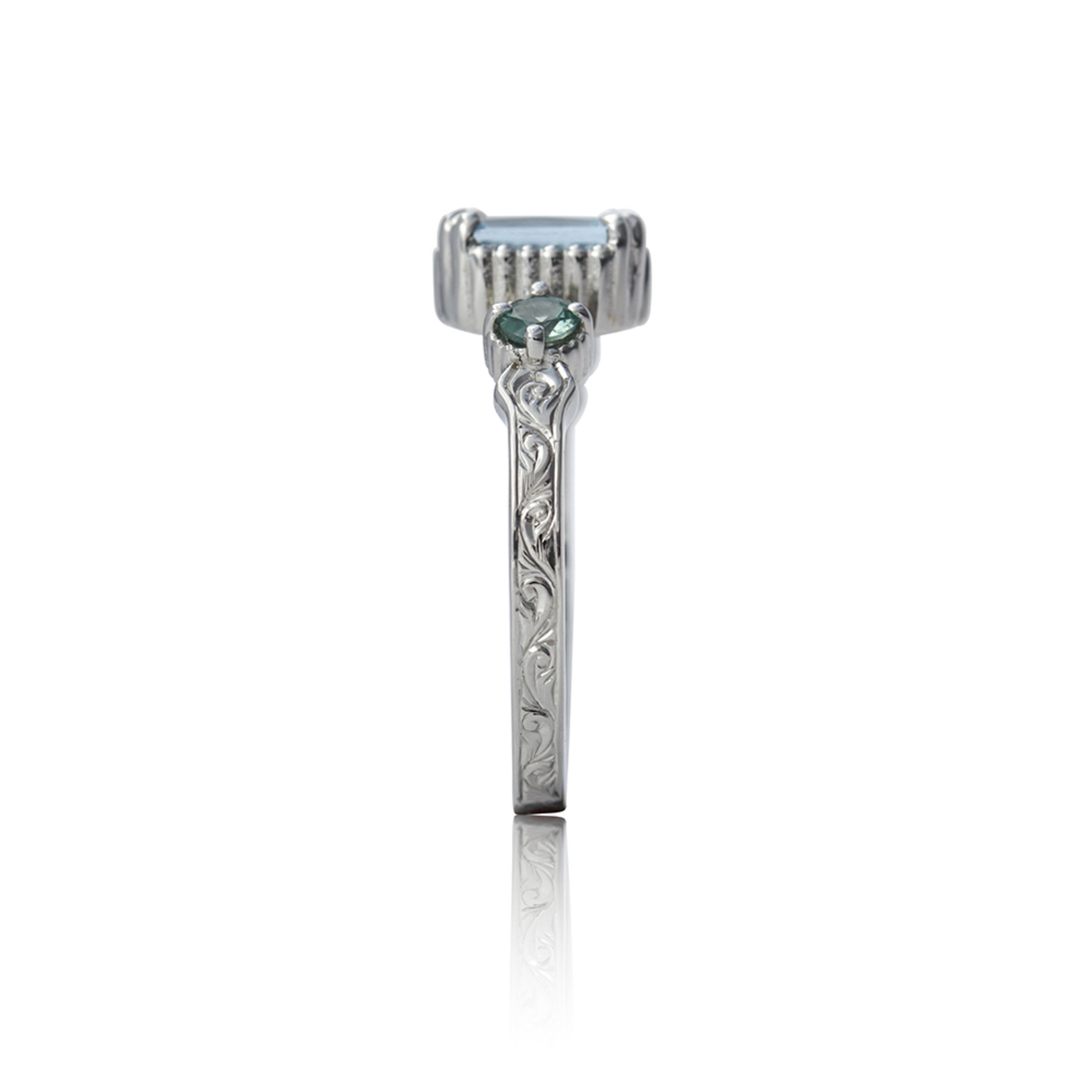 14kt gold vintage-style ring with emerald-cut aquamarine centre and two round alexandrite gemstones, featuring hand-engraved details.