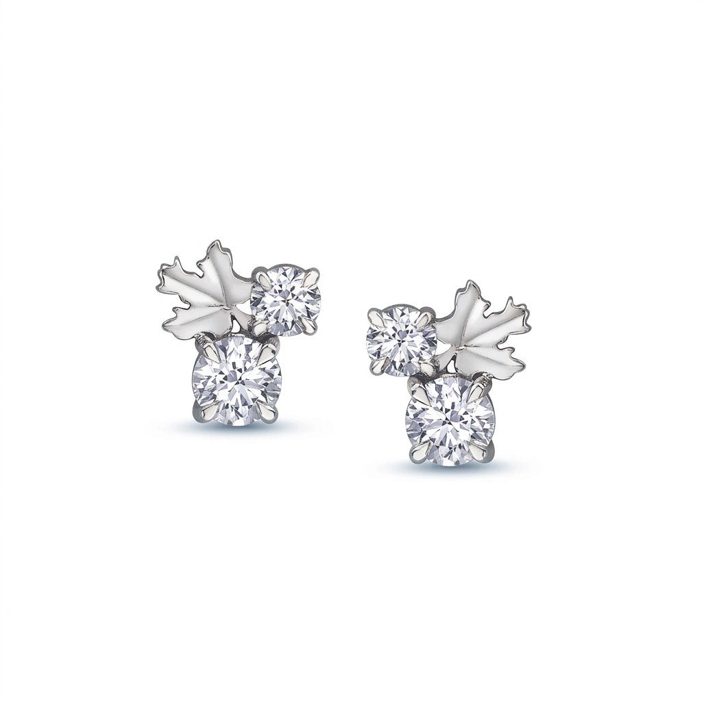 A pair of maple leaf-shaped stud earrings, with a Canadian diamond and two smaller surrounding diamonds, set in Canadian rose gold.