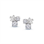 A pair of maple leaf-shaped stud earrings, with a Canadian diamond and two smaller surrounding diamonds, set in Canadian rose gold.