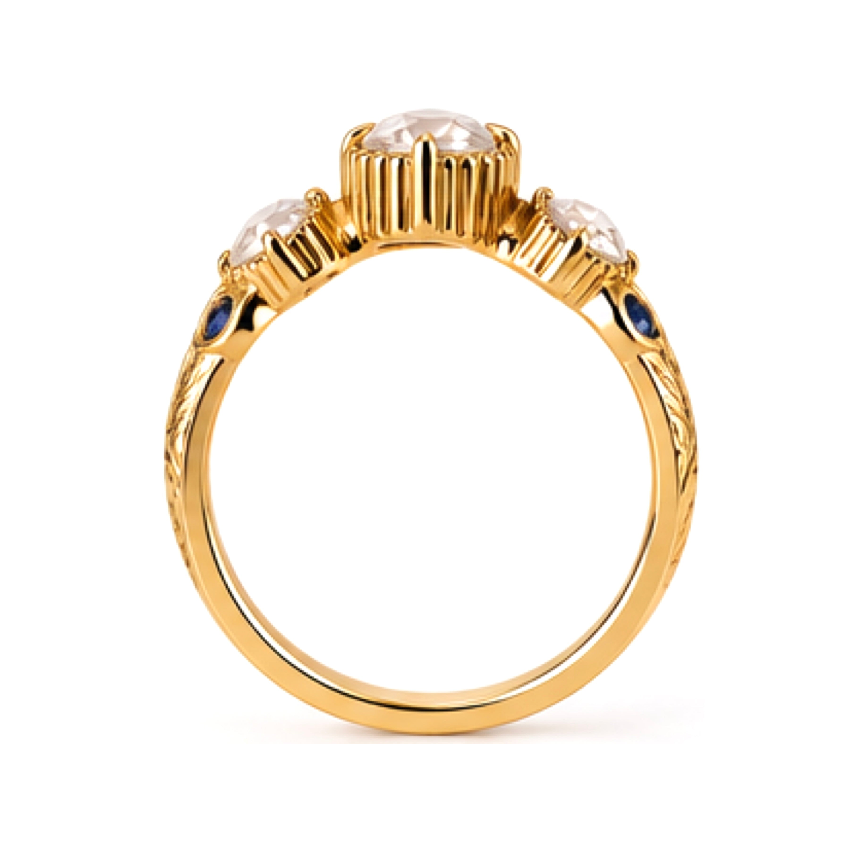 A gold ring featuring three round clear gemstones in a row of prong settings, accented by small round blue sapphires on the shoulders, shown against a plain white background.