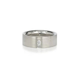 wide 14 karat white gold band with a channel set 5pt dianond