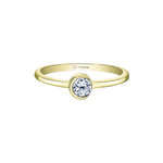 A gold crescent moon ring with a single diamond centerpiece, set on a white background.