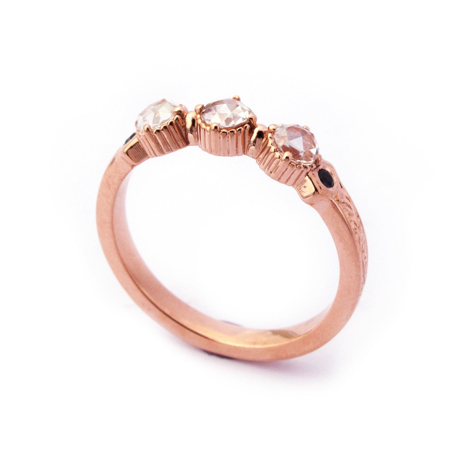 Crafted in 14KT rose gold, this ring features 3 round brilliant-cut diamonds in a row, with a blue sapphire on either side on a vintage-inspired hand engraved band.