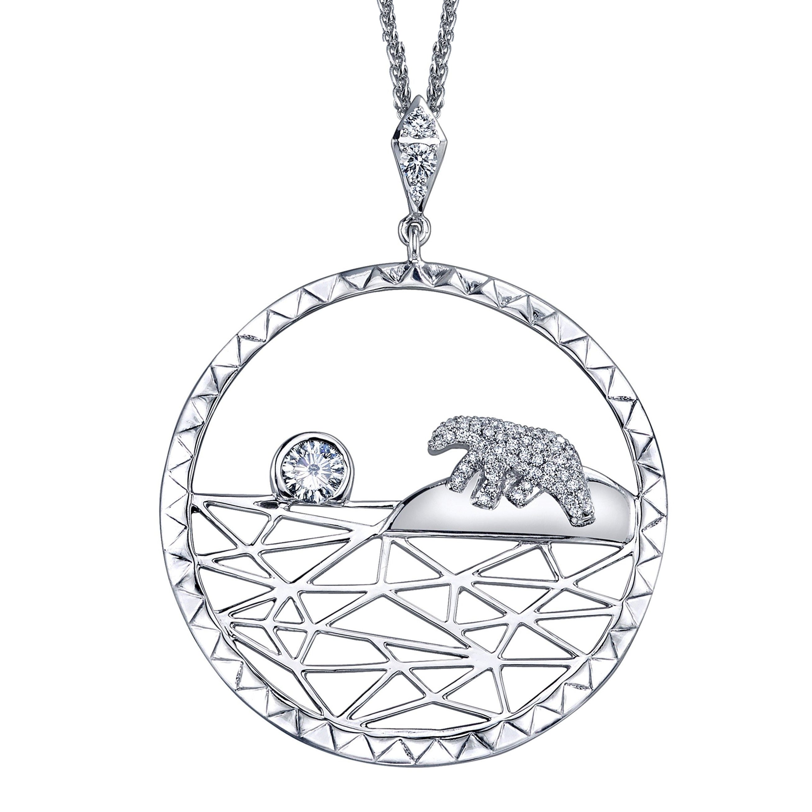 Crafted in 14KT white Certified Canadian Gold, this pendant features a diamond set polar bear and a round brilliant-cut Canadian diamond sun on an icy landscape. 
