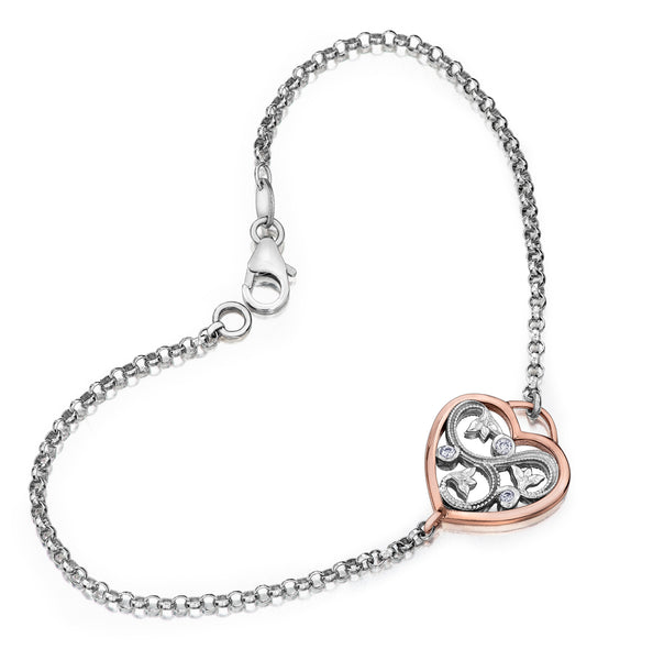 Crafted in 14KT white and rose Certified Canadian Gold, this bracelet features a rose vine design set with round brilliant-cut Canadian diamonds all enclosed in a heart shape. 
