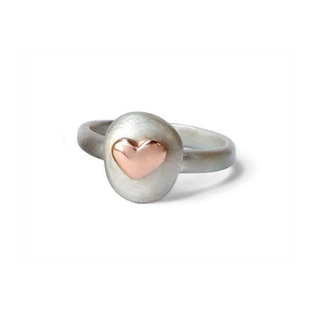 Crafted in brushed sterling silver, this smooth, organically shaped ring features an oval set with a small 14KT rose gold heart.