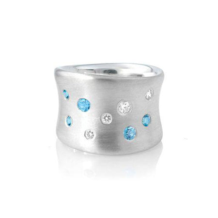 Crafted in brushed sterling silver, this smooth, organically shaped band is studded with both diamonds and blue topaz.