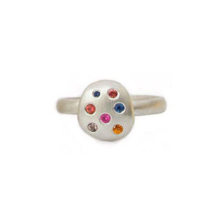 Crafted in brushed sterling silver, this smooth, organically shaped ring features an oval studded with an array of unique multi-coloured sapphires.