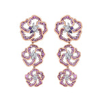 Crafted in 14K white Certified Canadian Gold, these dangling earrings feature three wildflowers set with amethyst, pink sapphires and round brilliant-cut Canadian diamonds.  