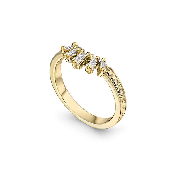 Crafted in 14KT yellow gold, this crown inspired ring features 5 tapered baguette diamonds in a row on a vintage-inspired hand engraved band.