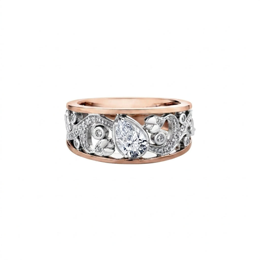 Crafted in 18kt Pure White™ and rose 18KT Certified Canadian Gold, this engagement ring features a diamond set rose vine design with a tilted pear shape Canadian centre diamond.