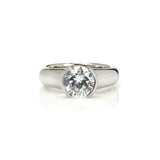 Crafted in 14KT white gold, this ring features a round-cut diamond in a half-bezel setting. 
