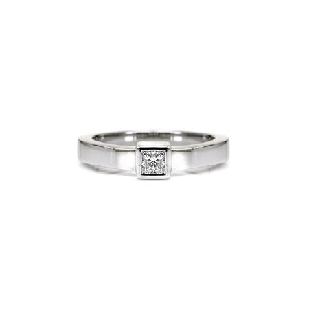 Crafted in 14KT white gold, this ring features a bezel set princess-cut diamond and a flat band.