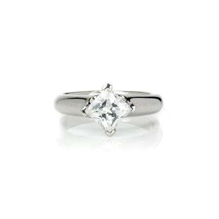 Crafted in 14KT white gold, this ring features a princess-cut diamond in a diagonal prong setting. 