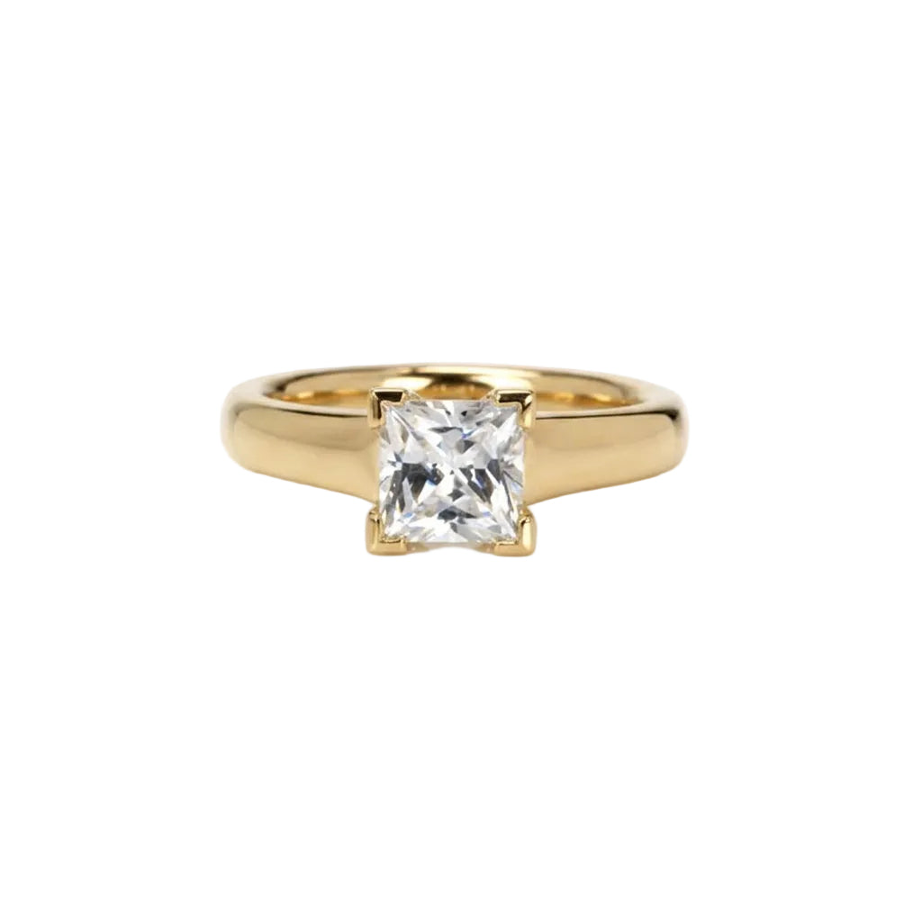  Crafted in 14KT gold, this engagement ring features a princess-cut diamond with v-shaped prongs holding it in place. 