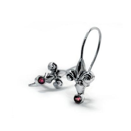 Crafted in oxidized sterling silver, these drop earrings each feature a Fleur de Lis set with a round-cut red garnet. 