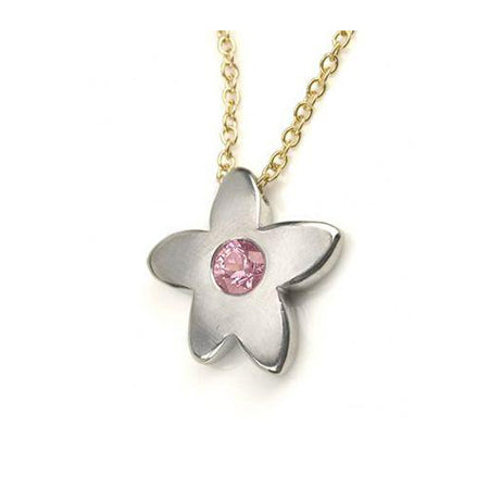Crafted in 14KT white gold, this necklace features a flower pendant with a pink sapphire centre. 