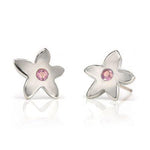 Crafted in 14KT white gold, these stud earrings each feature a flower with a pink sapphire centre. 
