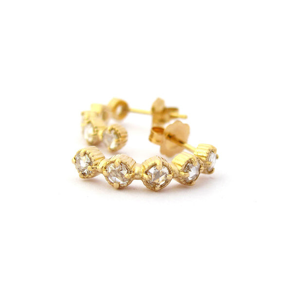 Crafted in 14KT yellow gold, these half-hoop earrings feature five rose-cut diamonds each in cupcake settings. 