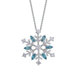 Crafted in 14KT white Certified Canadian Gold, this pendant features a snowflake set with blue topaz and round brilliant-cut Canadian diamonds.