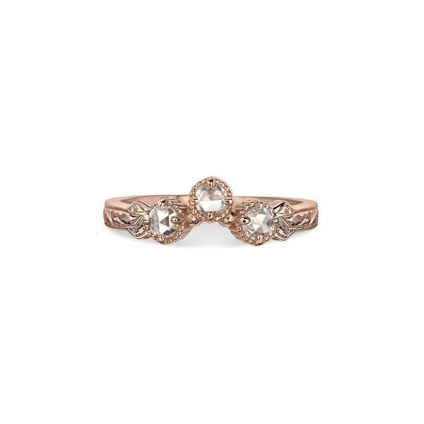 Crafted in 14KT rose gold, this ring has a curve featuring 3 rose-cut diamonds in a row on a vintage-inspired hand engraved band.