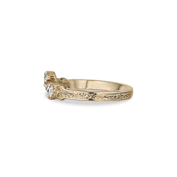 Crafted in 14KT yellow gold, this ring has a curve featuring 3 rose-cut diamonds in a row on a vintage-inspired hand engraved band.