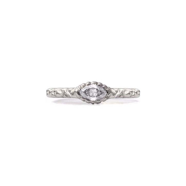Crafted in 14KT brushed white gold, this ring features a bezel-set marquise-cut diamond on a quilted band. 